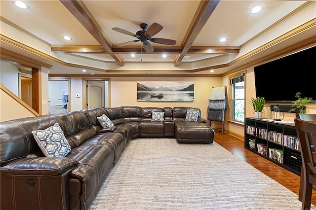 living room with beamed ceiling, hardwood / wood-style flooring, ornamental molding, ceiling fan, and coffered ceiling