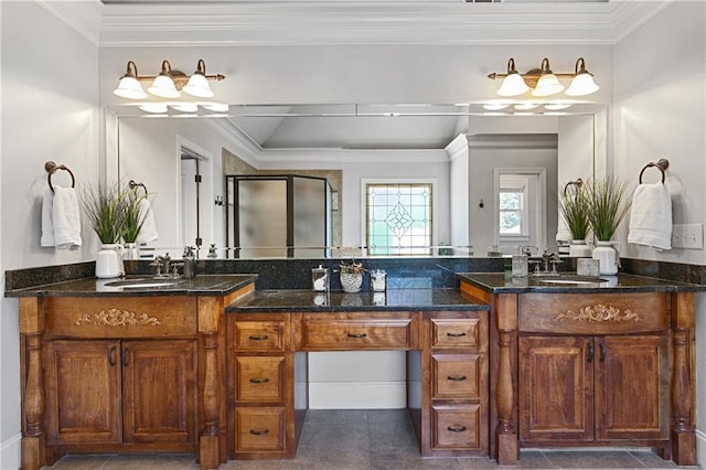 bathroom with tile patterned floors, a shower with shower door, vanity, and ornamental molding