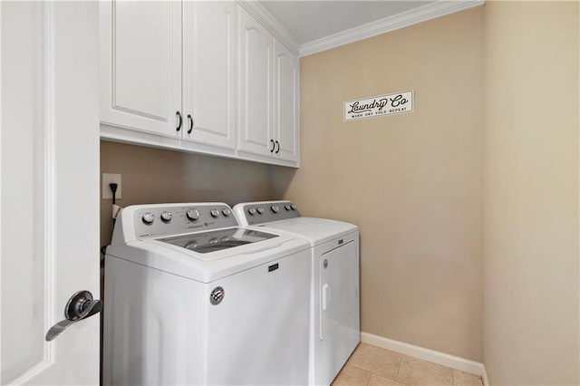 laundry area featuring cabinets, light tile patterned floors, crown molding, and washing machine and clothes dryer