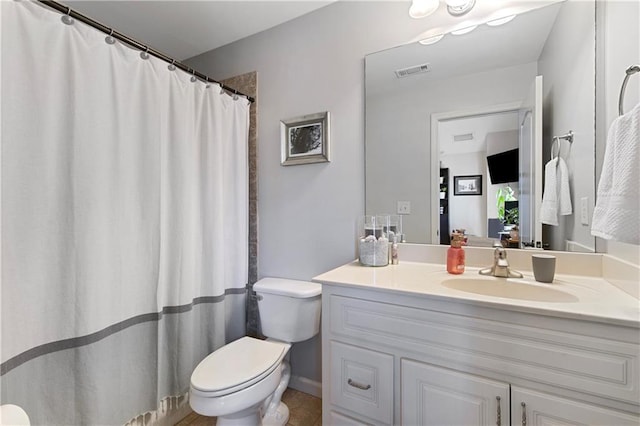 bathroom featuring toilet and vanity