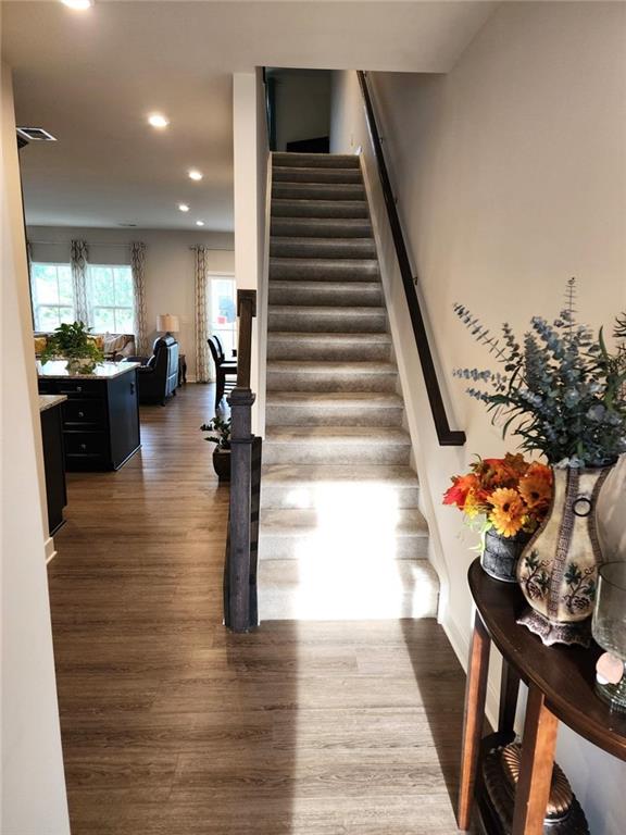 staircase with wood-type flooring