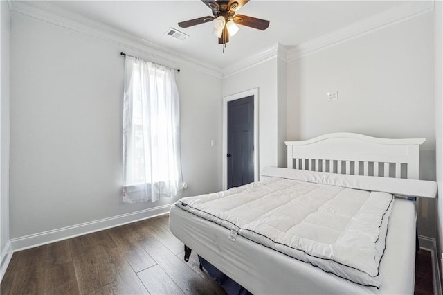 bedroom with ceiling fan, visible vents, crown molding, wood finished floors, and baseboards