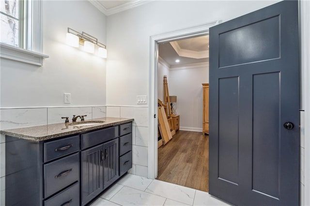 bathroom featuring crown molding, tile walls, a wainscoted wall, vanity, and marble finish floor