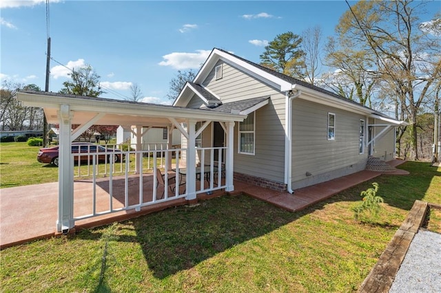 view of home's exterior featuring covered porch and a yard