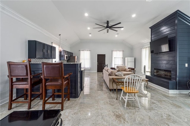 living room featuring a healthy amount of sunlight, baseboards, and vaulted ceiling