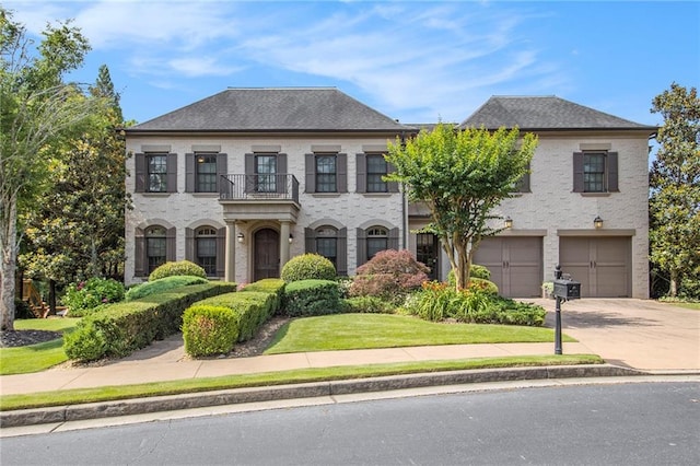 3015 Southmoor Trce, Roswell, GA 30075 - view of front of house featuring a balcony, concrete driveway, an attached garage, and a front yard