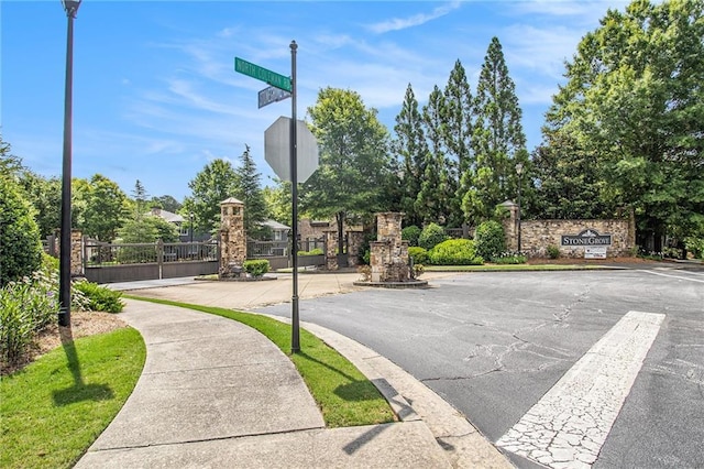 3015 Southmoor Trce, Roswell, GA 30075 - view of asphalt street with sidewalks, traffic signs, and street lights