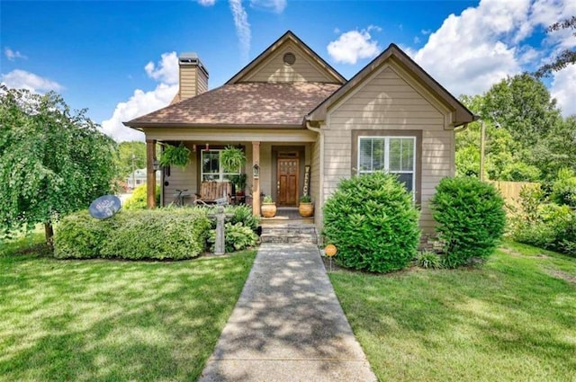 view of front of property with covered porch and a front yard