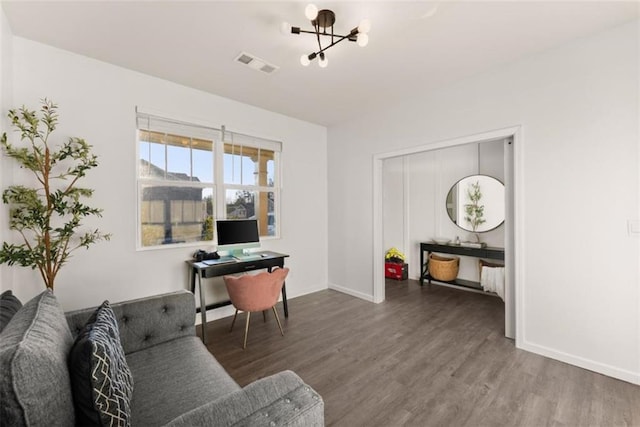 living room featuring dark hardwood / wood-style floors and a notable chandelier