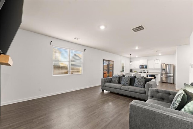 living room with dark hardwood / wood-style floors