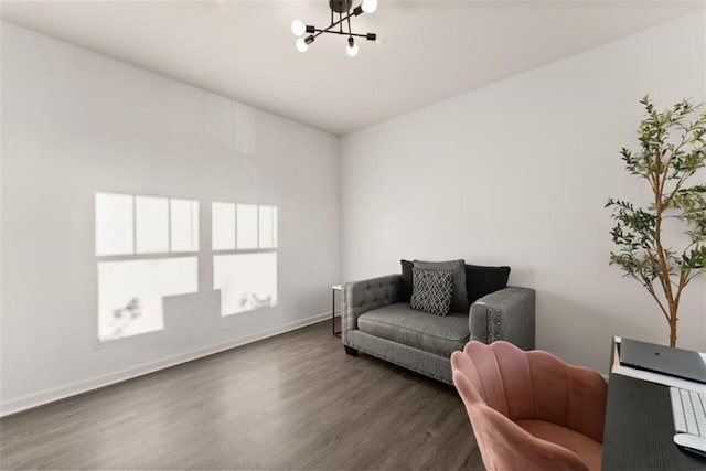 office area with dark wood-type flooring and a notable chandelier