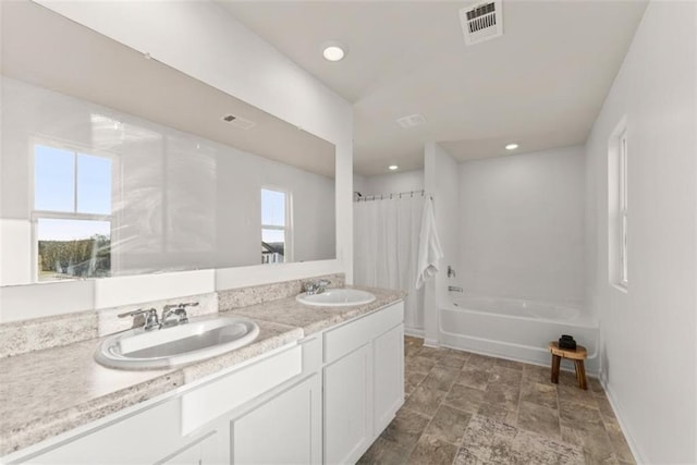 bathroom featuring vanity and shower / bath combination