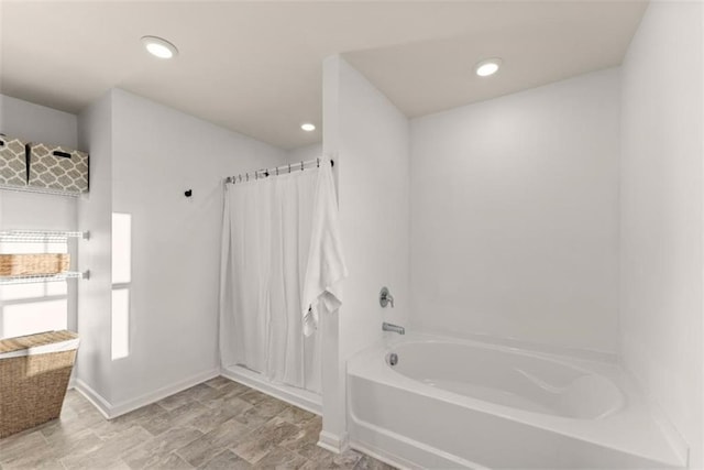 bathroom featuring shower with separate bathtub