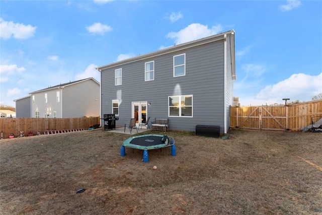 rear view of house with a yard and a patio