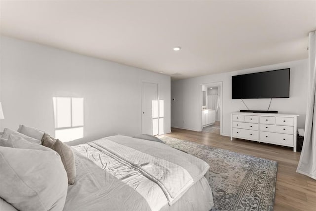 bedroom with multiple windows and hardwood / wood-style floors