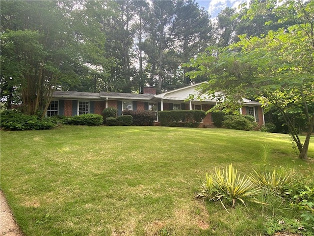 3794 W Hayward Ct, Tucker, GA 30084 - view of front of property featuring a front lawn, a chimney, and brick siding