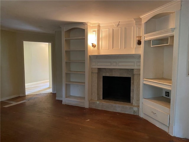 3794 W Hayward Ct, Tucker, GA 30084 - unfurnished living room featuring wood finished floors, a tiled fireplace, and baseboards