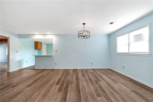 interior space with a chandelier and hardwood / wood-style flooring