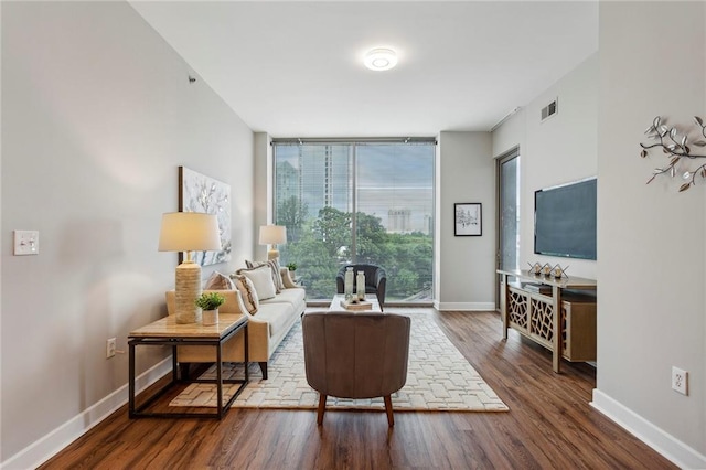 living room with dark hardwood / wood-style flooring and expansive windows