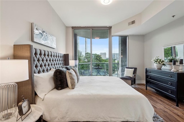 bedroom with access to outside, dark hardwood / wood-style flooring, and expansive windows