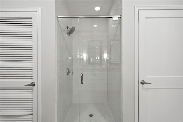 bathroom with a shower with shower door