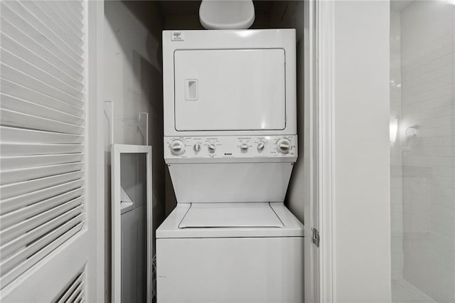 washroom featuring stacked washer and dryer