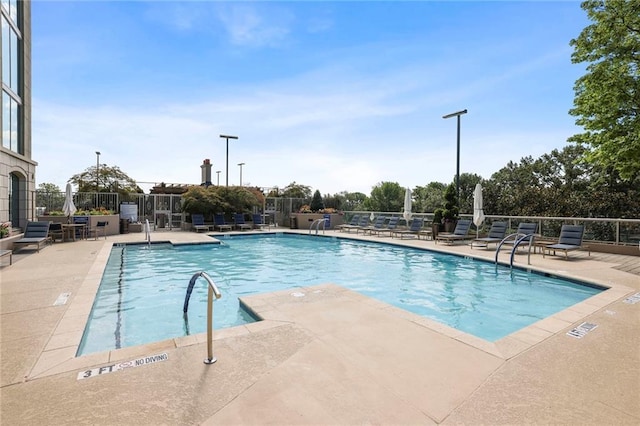 view of swimming pool with a patio