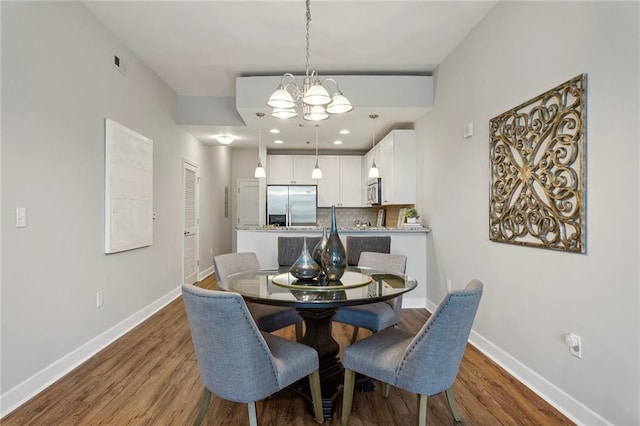 dining area with a chandelier and hardwood / wood-style flooring