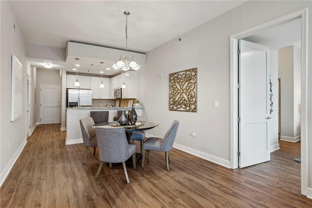 dining area with a chandelier and hardwood / wood-style flooring