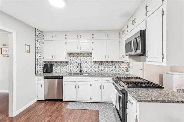1752 Shadybrook Ct, Lawrenceville, GA 30043 - kitchen with appliances with stainless steel finishes, a sink, dark wood-style flooring, and white cabinetry