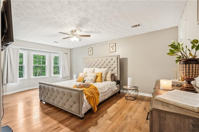 1752 Shadybrook Ct, Lawrenceville, GA 30043 - bedroom featuring light wood-type flooring, baseboards, a ceiling fan, and a textured ceiling