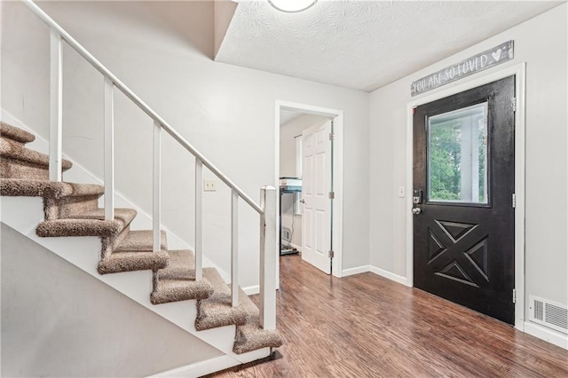 1752 Shadybrook Ct, Lawrenceville, GA 30043 - foyer with stairs, wood finished floors, baseboards, and a textured ceiling