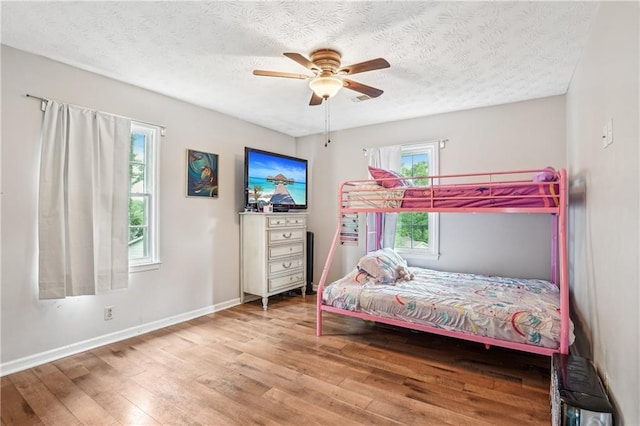 1752 Shadybrook Ct, Lawrenceville, GA 30043 - bedroom featuring hardwood / wood-style flooring, baseboards, a textured ceiling, and a ceiling fan
