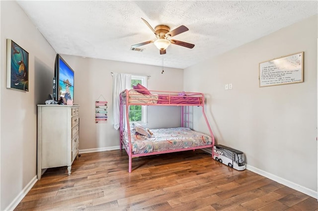 1752 Shadybrook Ct, Lawrenceville, GA 30043 - bedroom with wood finished floors, baseboards, a textured ceiling, and a ceiling fan