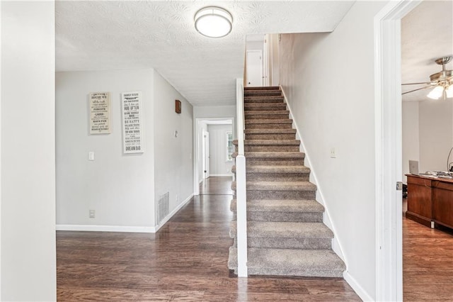 1752 Shadybrook Ct, Lawrenceville, GA 30043 - stairway with wood finished floors, a ceiling fan, a textured ceiling, and baseboards