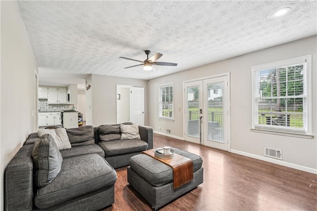 1752 Shadybrook Ct, Lawrenceville, GA 30043 - living room featuring dark wood-style floors, ceiling fan, baseboards, and a textured ceiling