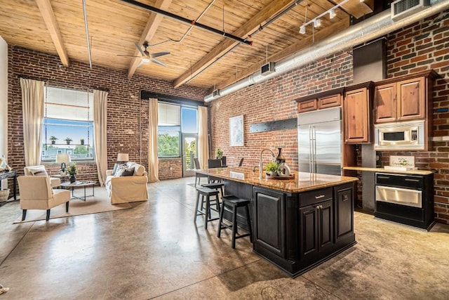 204 Walker St SW Unit 319, Atlanta, GA 30313 - kitchen featuring brick wall, built in appliances, wooden ceiling, a high ceiling, and concrete flooring