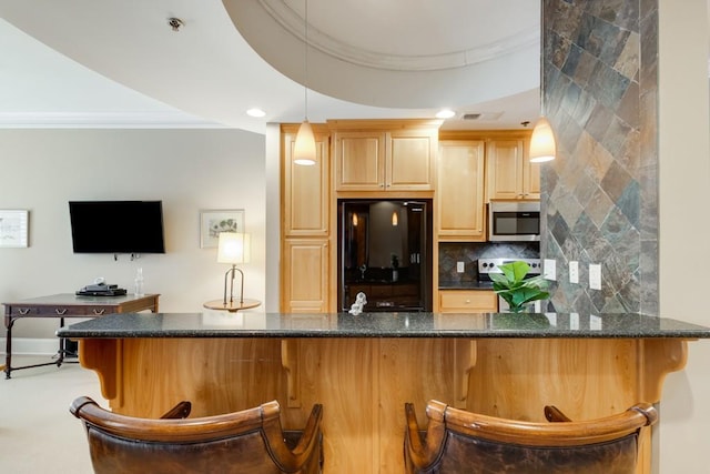 bar featuring hanging light fixtures, stainless steel appliances, backsplash, ornamental molding, and light brown cabinetry