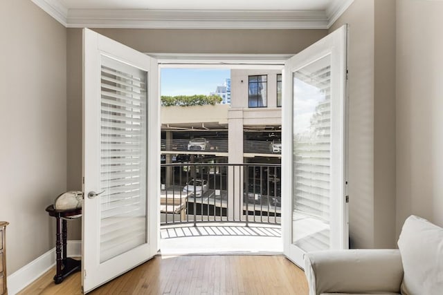 doorway with crown molding and hardwood / wood-style flooring