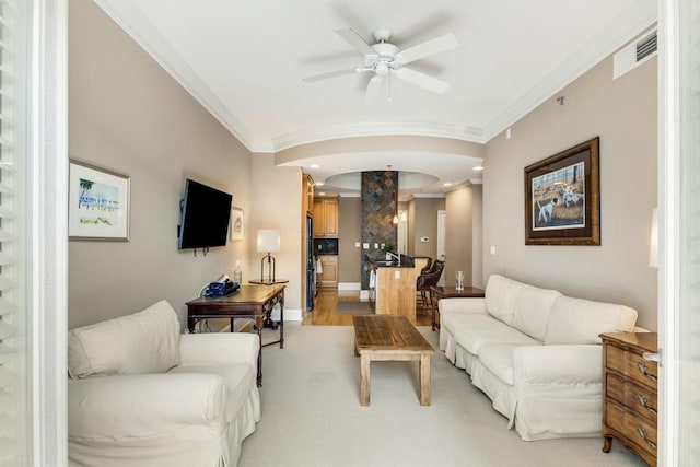 living room featuring crown molding and ceiling fan