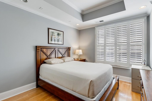 bedroom with crown molding and light hardwood / wood-style floors