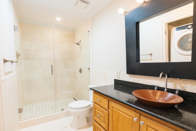 bathroom with vanity, toilet, tile patterned floors, and a shower with door