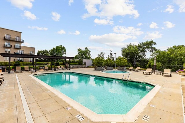 view of pool with a patio area and a community hot tub