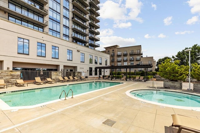 view of pool with a community hot tub and a patio