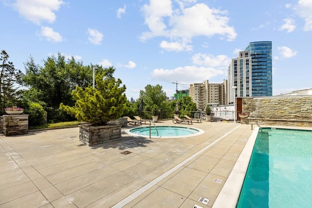 view of swimming pool featuring a patio