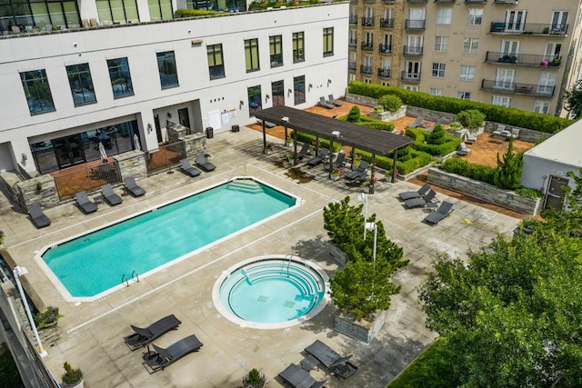 view of swimming pool featuring a patio area and a community hot tub