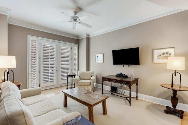 living room with crown molding, light hardwood / wood-style floors, and ceiling fan