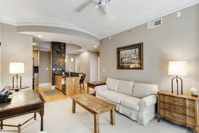 living room with light hardwood / wood-style floors, ornamental molding, sink, and ceiling fan