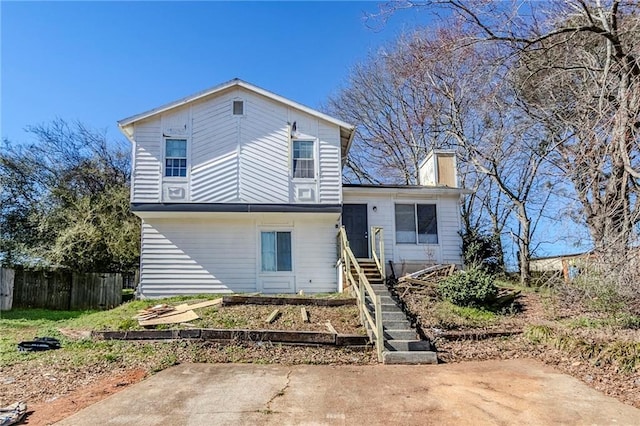 view of front of property with fence and a chimney