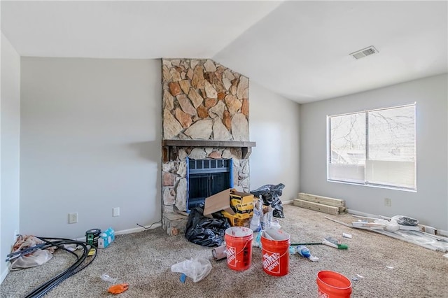 carpeted living area with baseboards, a fireplace, visible vents, and vaulted ceiling